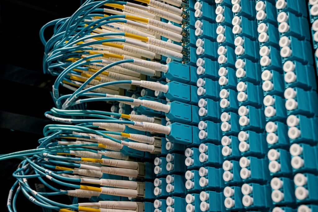 Fiber optic patch cables plugged into a blue patch panel